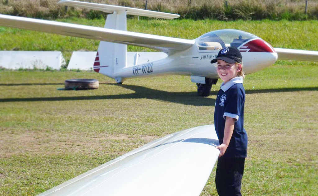 Natural in a plane, Lydia Stewart, helps move a glider at the Air League cadets camp at Gympie Airfield. Natural in a plane, Lydia Stewart, helps move a glider at the Air League cadets camp at Gympie Airfield.